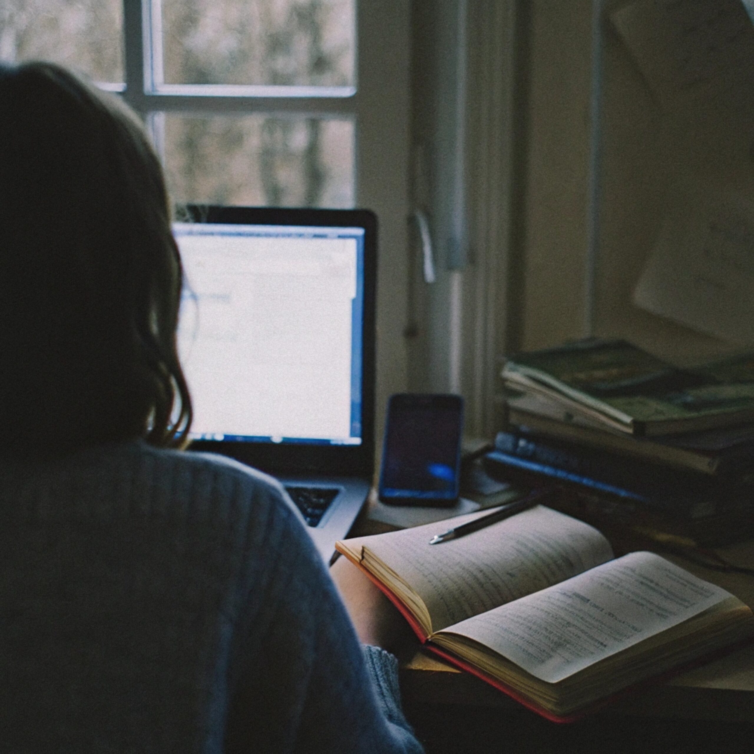 Student writing in notebook